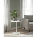 SKANDY white side table beside armchair with books and plants