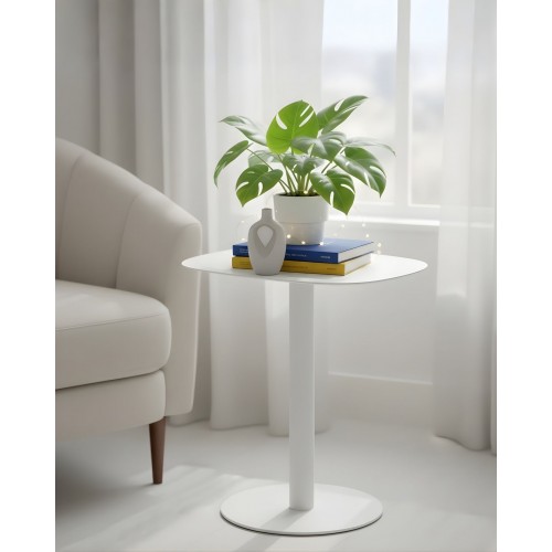 SKANDY white side table beside armchair with books