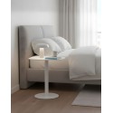 SKANDY white end table next to bed with lamp and book